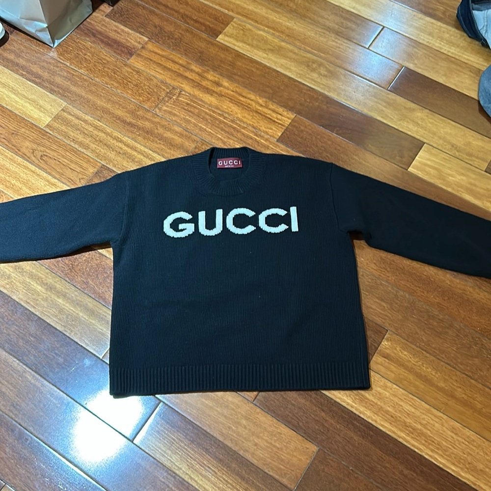 Authentic black Gucci wool sweater withh white writing.
